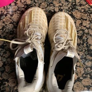 Gold and white adidas cleets